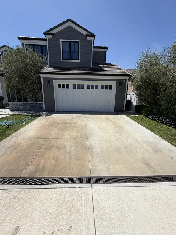 Concrete driveway yellowed and stained before pressure washing