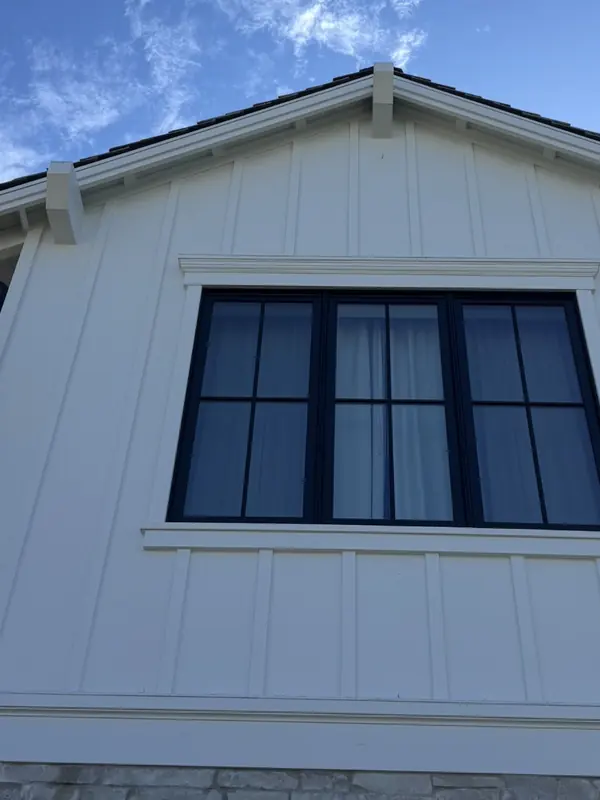 The same white siding bright and clean after a soft wash