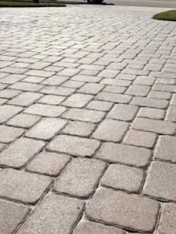 Close-up of faded, dirty pavers before restoration