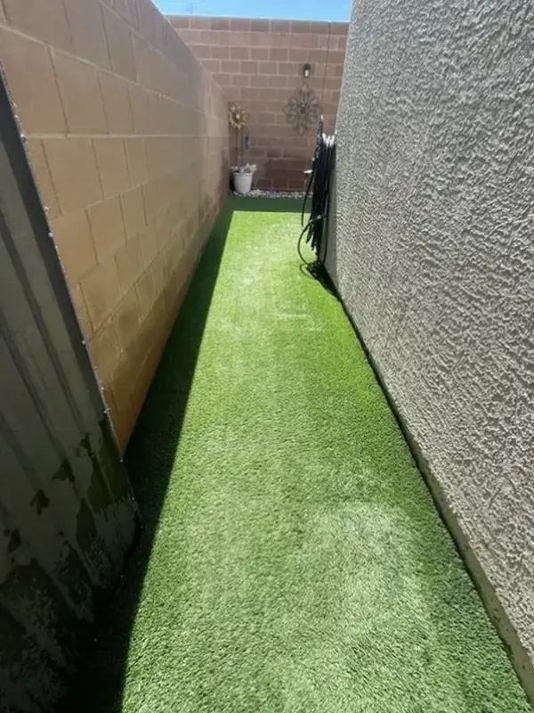 The same side yard with clean, bright turf