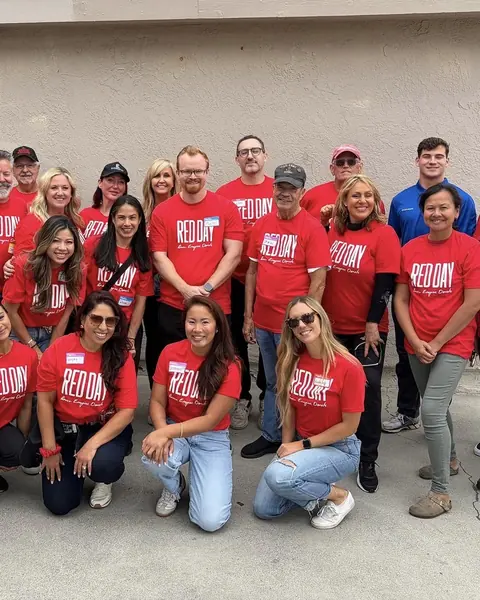 Volunteers in red shirts and the Titan crew at the Boys and Girls Club