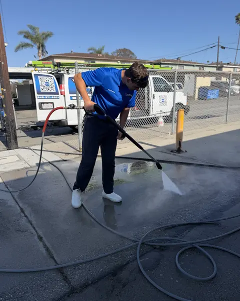 Titan crew member pressure washing concrete at the Boys and Girls Club