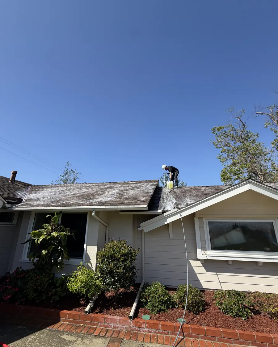 Titan crew member washing the roof of a home being listed for sale