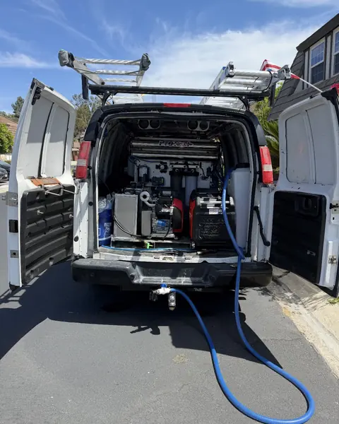 The back of the Titan van open with hoses run out