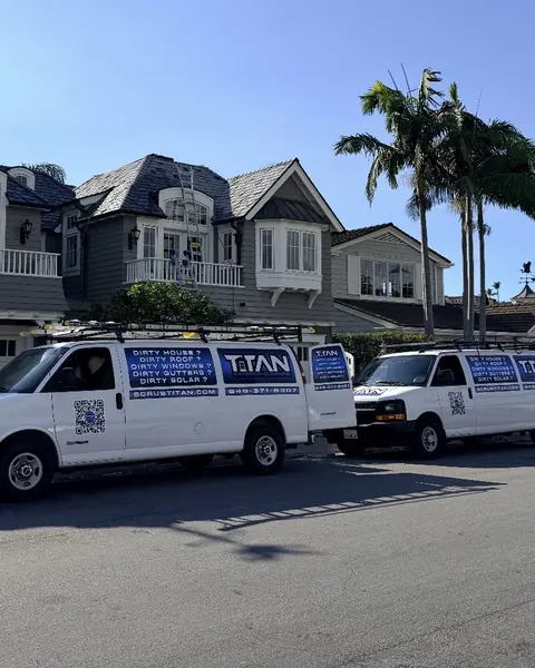 Two Titan vans parked on a residential street