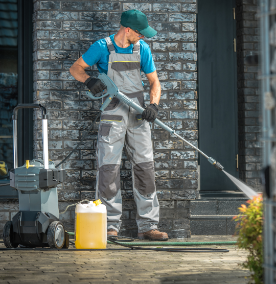 Pressure washing a sidewalk in Huntington Beach